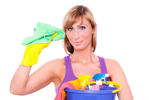 Professional cleaner in Merton working in a bright living room
