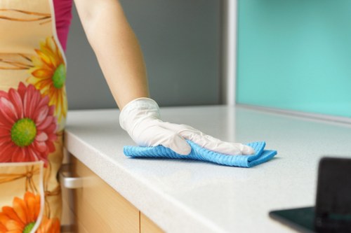 Ongoing cleaning tasks in a Merton kitchen and living area