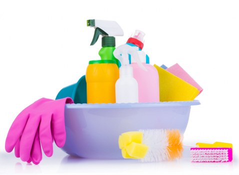 Cleaner treating stains on a lounge sofa during sofa cleaning in Merton